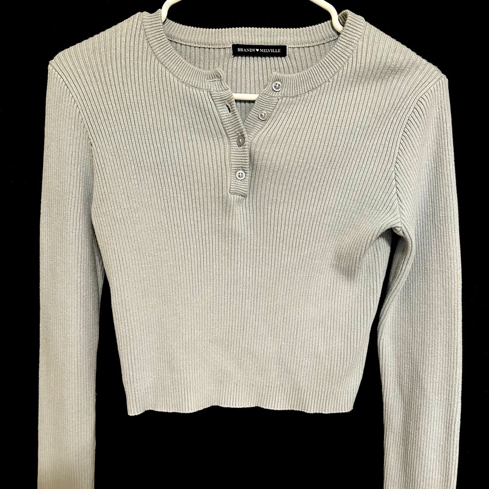 Women’s Brandy Melville cropped light blue ribbed sweater w button detailing.
